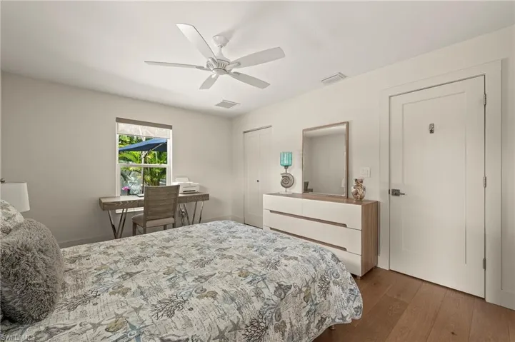 Bedroom featuring ceiling fan, a closet, visible vents, and wood finished floors