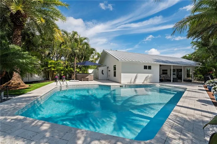 View of pool featuring a fenced in pool, a patio, and a hot tub
