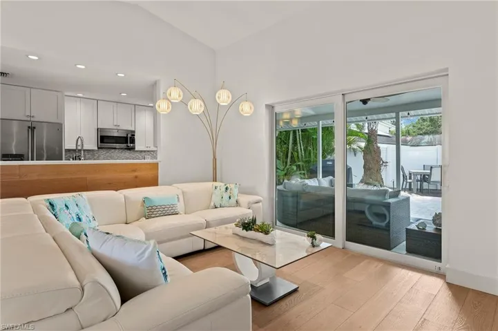 Living room featuring light wood-style floors, recessed lighting, and visible vents