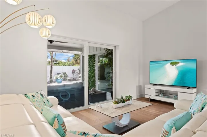 Living room featuring lofted ceiling and wood finished floors