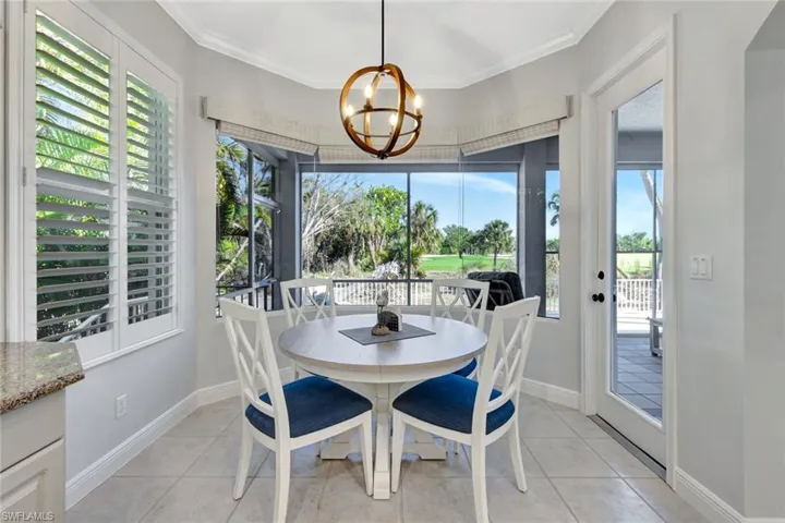 Breakfast area with a chandelier and views to patio and golf course