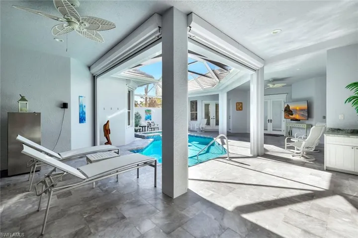 View of pool with ceiling fan
