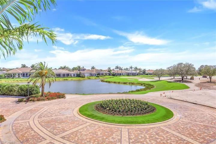 View of property's community featuring curved driveway, a residential view, and a water view