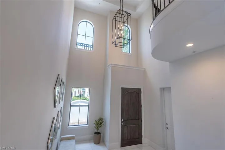 Foyer with grand marble staircase and elevator