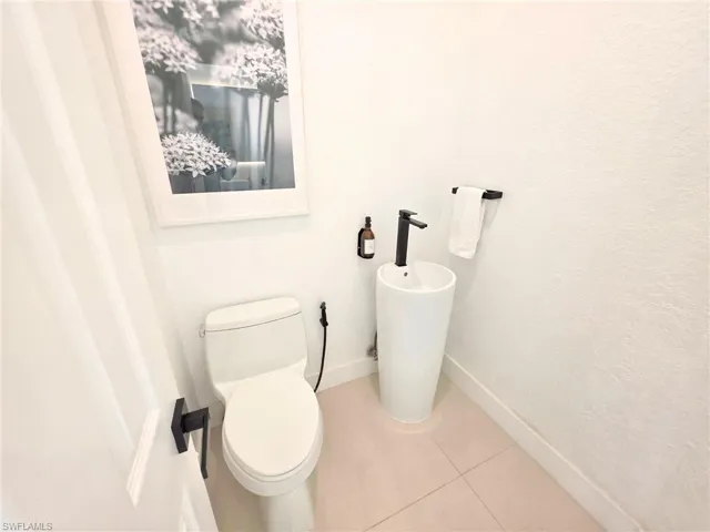 Bathroom featuring toilet and tile patterned flooring