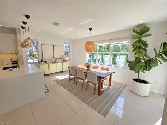 Dining area featuring light tile patterned floors and recessed lighting