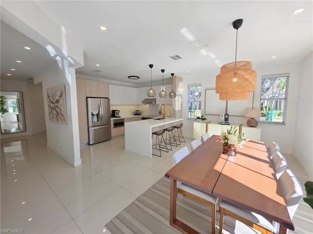 Dining space featuring light tile patterned flooring, plenty of natural light, and recessed lighting