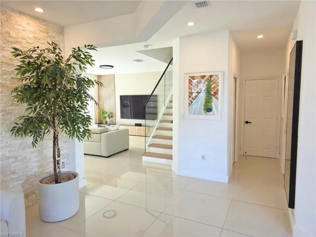 Corridor featuring light tile patterned flooring and recessed lighting
