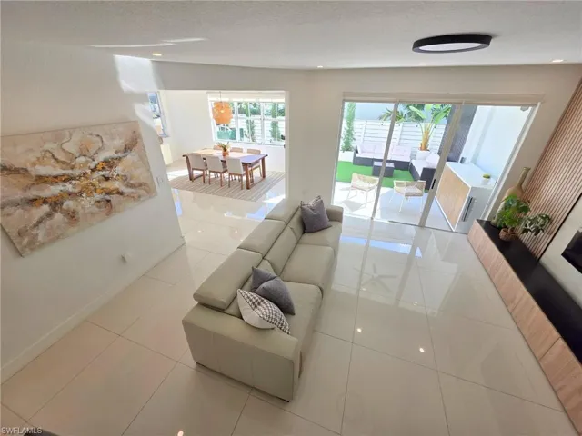 Living room featuring baseboards and light tile patterned flooring