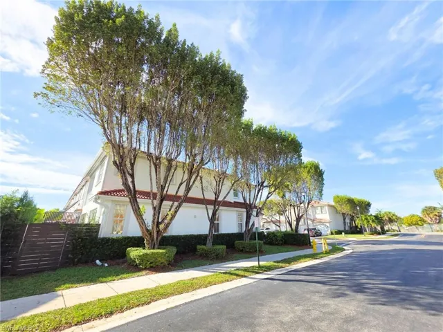 View of asphalt road with sidewalks and curbs