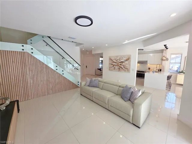 Living area featuring light tile patterned flooring and recessed lighting