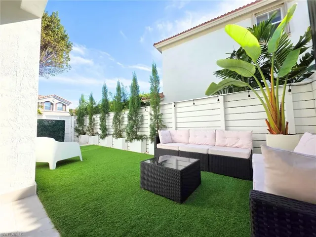 Fenced backyard with an outdoor lounge area