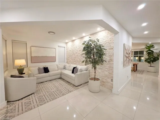 Tiled living room featuring recessed lighting