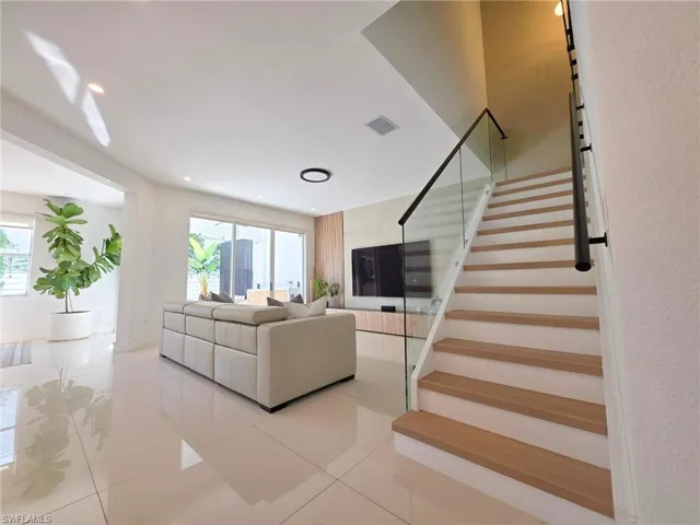 Living area featuring light tile patterned floors and recessed lighting