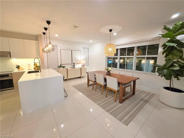 Dining area featuring recessed lighting and light tile patterned floors