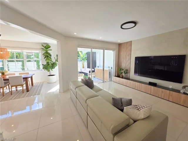 Living room featuring plenty of natural light, light tile patterned flooring, and recessed lighting