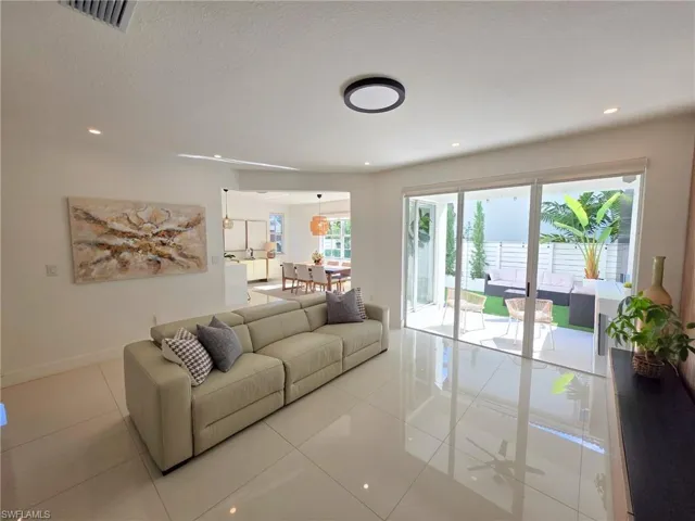 Living area featuring light tile patterned floors and recessed lighting