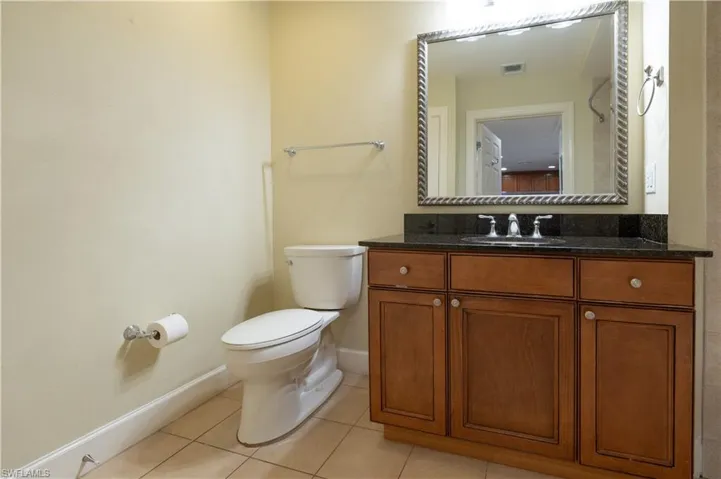 Bathroom featuring tile flooring, toilet, and vanity