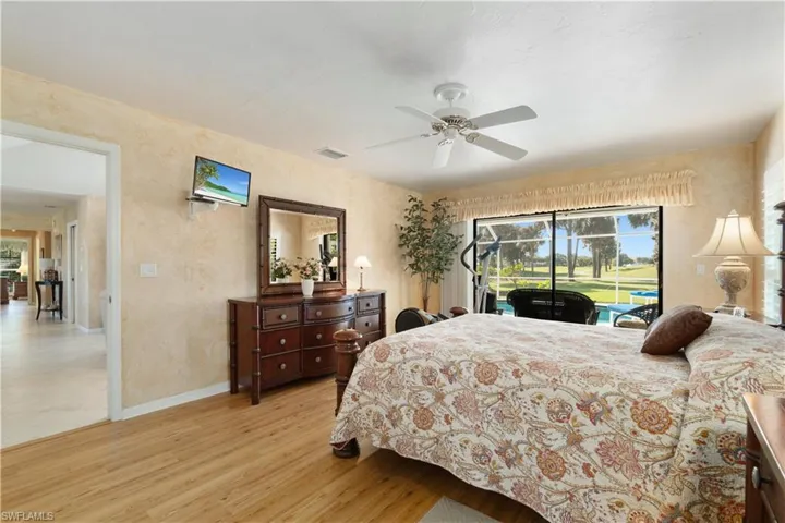 Bedroom featuring access to exterior, ceiling fan, and light hardwood / wood-style flooring