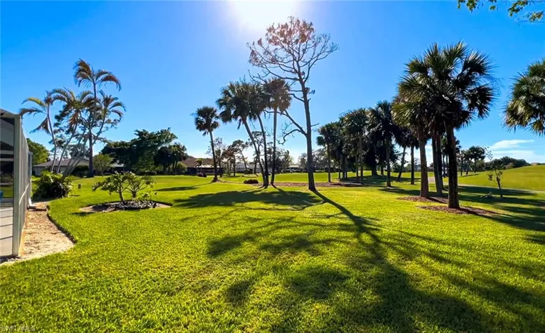 View of home's community with a lawn