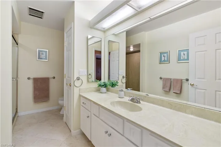 Bathroom with tile patterned floors, vanity, and toilet