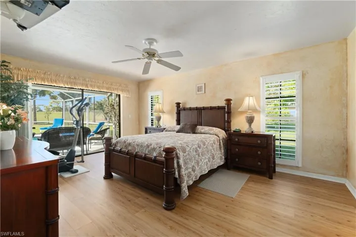 Bedroom with access to outside, ceiling fan, and light hardwood / wood-style floors