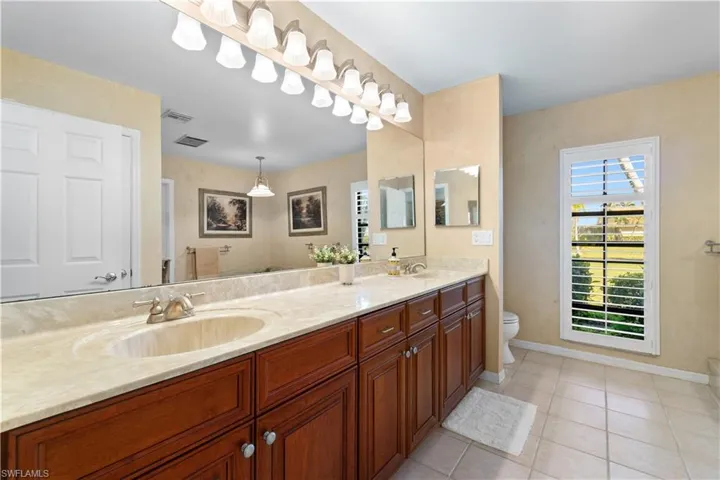Bathroom with tile patterned floors, vanity, and toilet