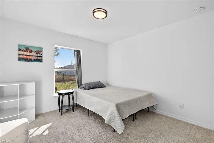 Bedroom with light colored carpet