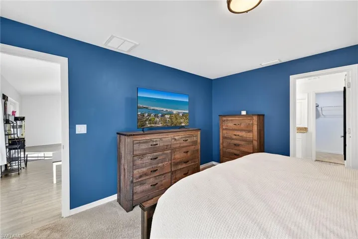Carpeted bedroom with baseboards