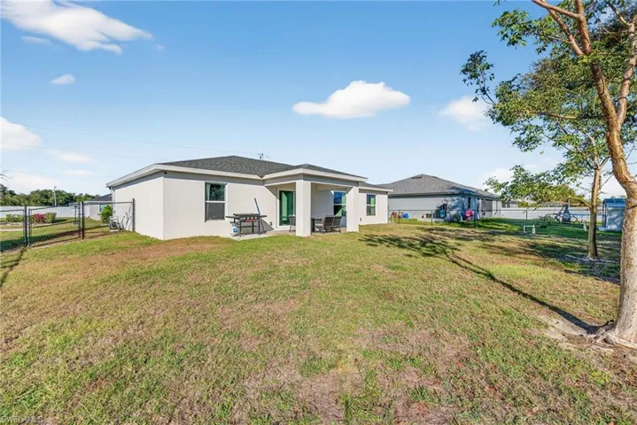 Back of property with stucco siding and a patio area