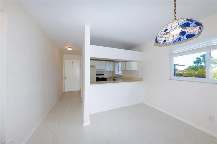 Entry Foyer and kitchen from the living room. Shows large living room window.
