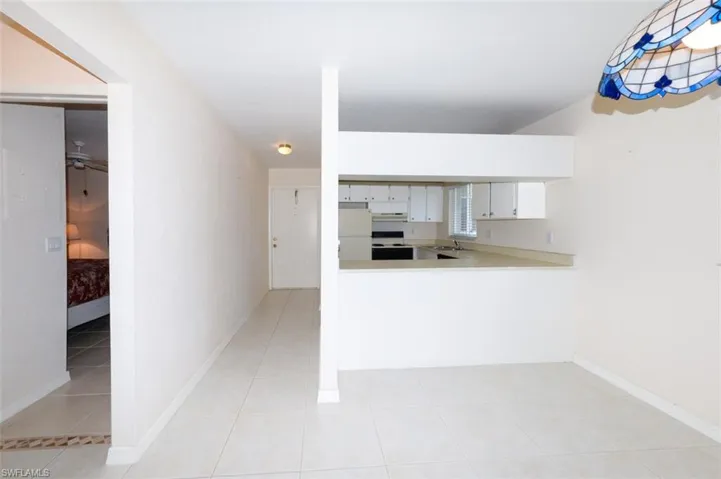 Entry Foyer and kitchen from the living room. Shows guest bedroom to the left.