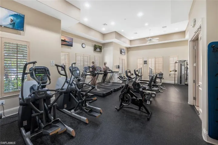 Exercise room with recessed lighting and a ceiling fan