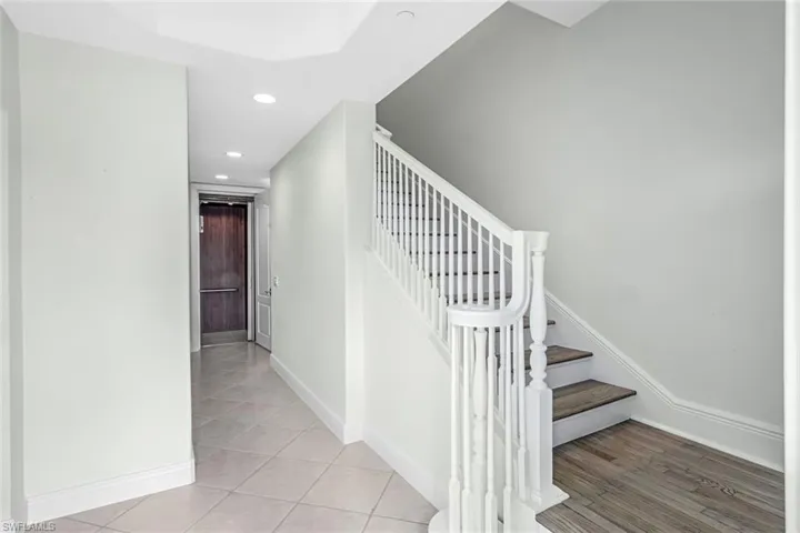 Staircase featuring recessed lighting and tile patterned floors