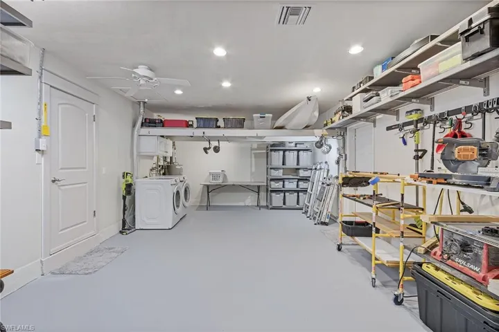 Basement featuring ceiling fan and washing machine and clothes dryer
