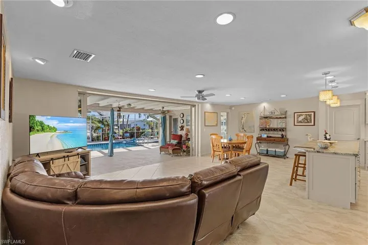 Tiled living room featuring ceiling fan