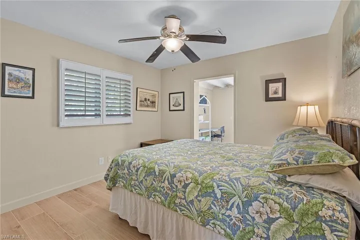Bedroom with ceiling fan and light hardwood / wood-style flooring