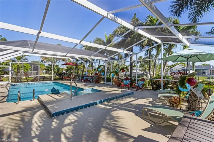 View of swimming pool with a lanai and a patio area