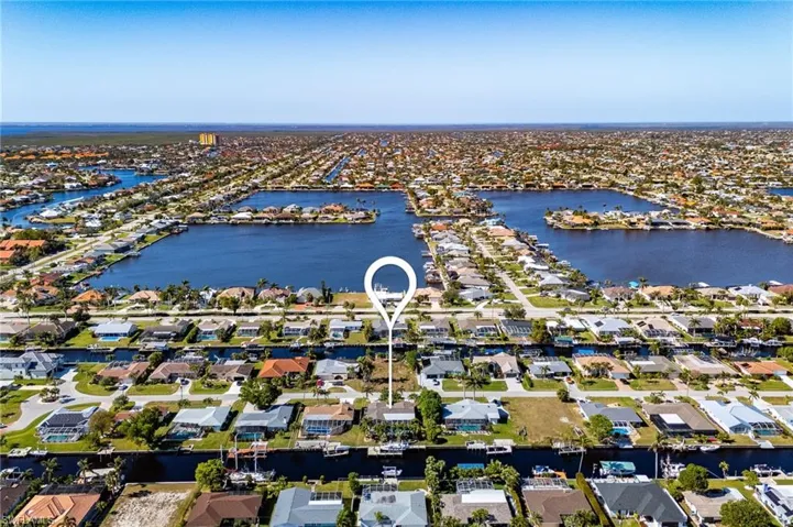 Birds eye view of property with a water view