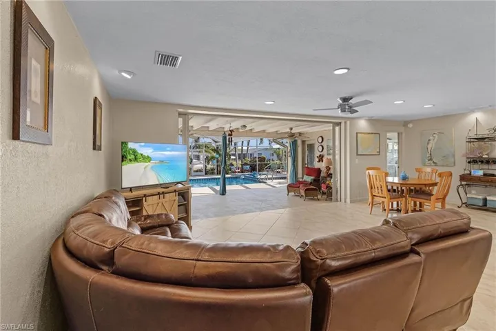 Living room featuring ceiling fan and light tile patterned floors