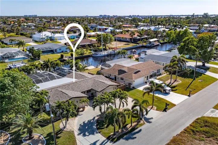 Birds eye view of property with a water view