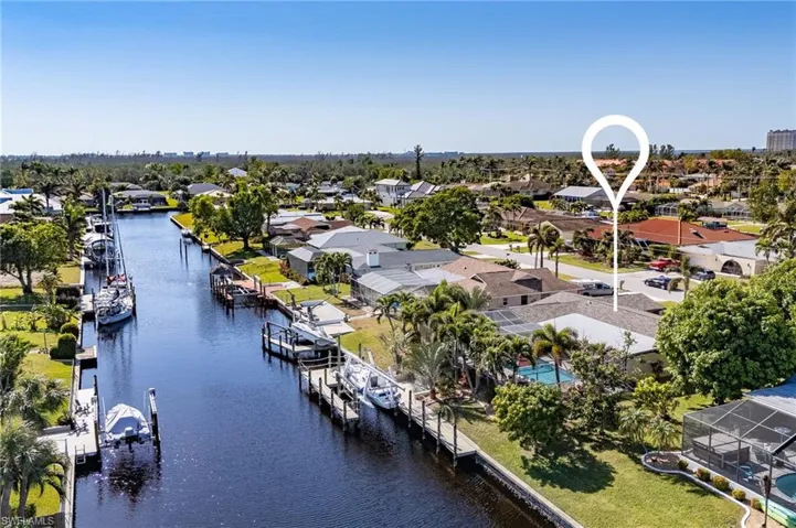 Birds eye view of property with a water view