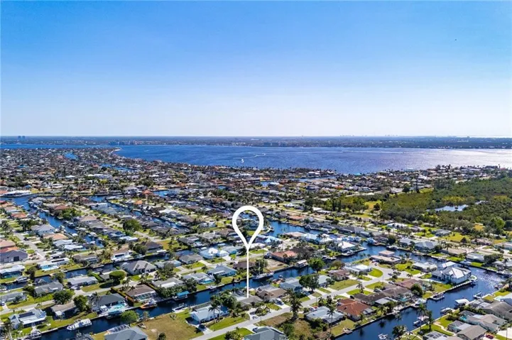 Birds eye view of property with a water view