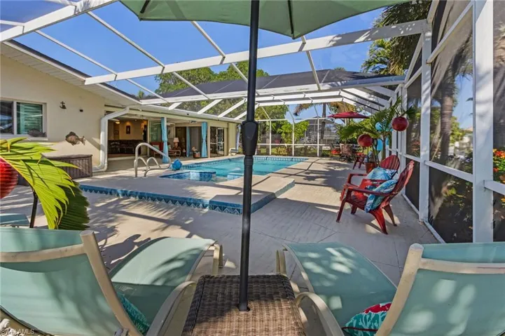 View of swimming pool with a lanai and a patio
