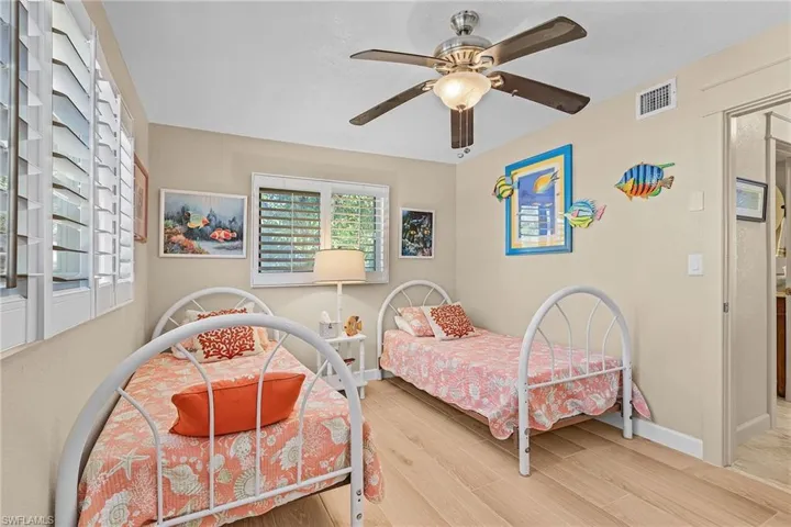 Bedroom featuring hardwood / wood-style floors and ceiling fan
