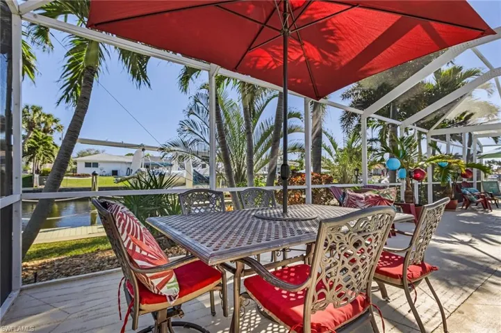 Wooden deck with a lanai and a water view