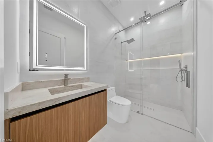 Bathroom with vanity and a shower stall