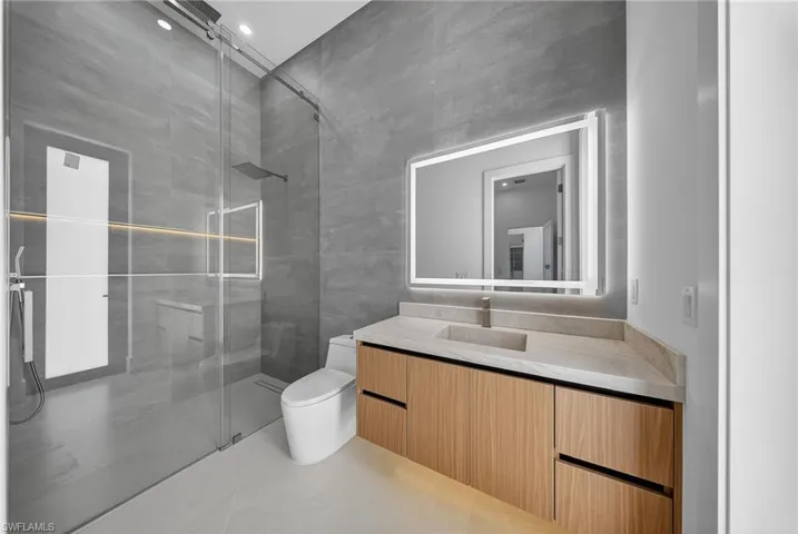 Bathroom featuring vanity and a shower stall