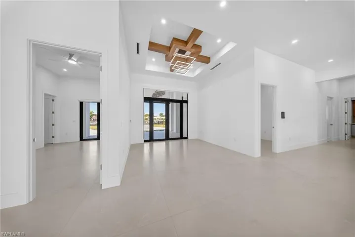 Spare room featuring coffered ceiling, recessed lighting, and ceiling fan