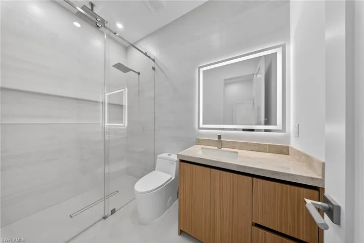 Bathroom featuring vanity and a shower stall